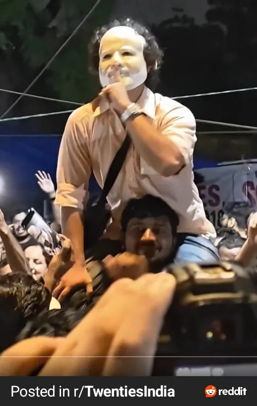 Masked participant above night crowd