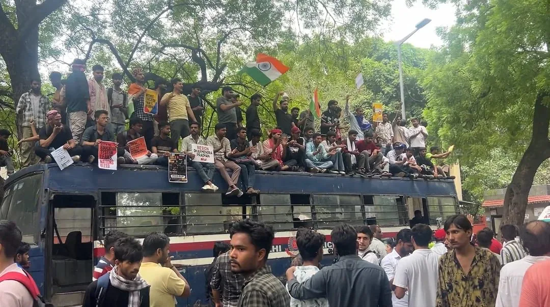 People seated atop a police bus