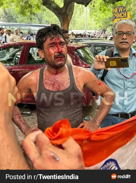 Injured man holding Indian flag
